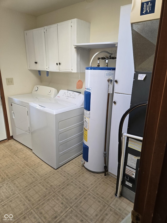 laundry room featuring separate washer and dryer, cabinets, and water heater