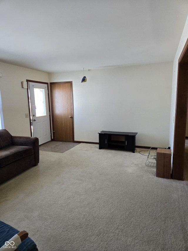 unfurnished living room featuring light carpet