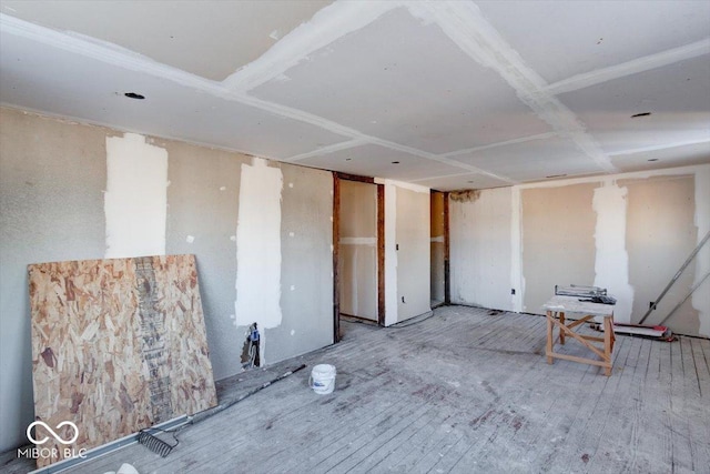 unfurnished room with wood-type flooring