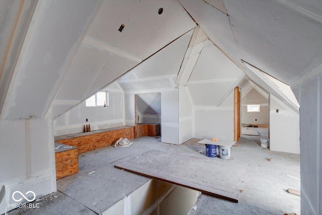 additional living space featuring lofted ceiling