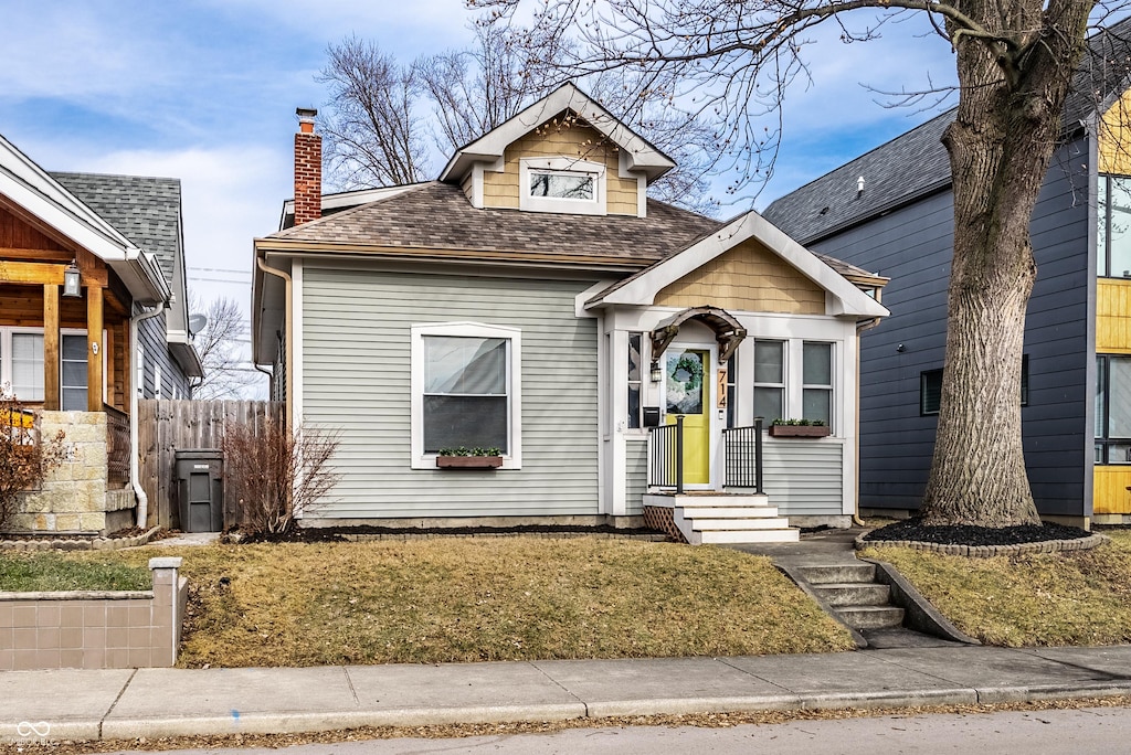 bungalow-style home featuring a front lawn