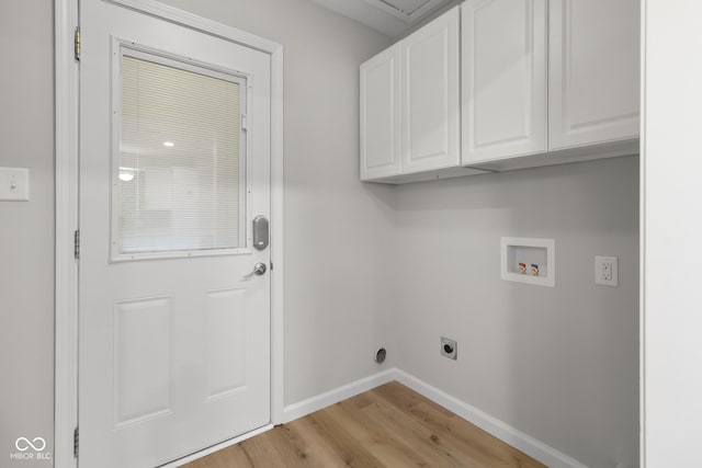 laundry room with washer hookup, cabinets, light hardwood / wood-style floors, and electric dryer hookup