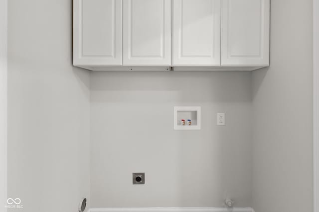 laundry room featuring cabinets, hookup for a washing machine, and electric dryer hookup