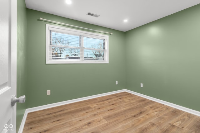 unfurnished room with light wood-type flooring