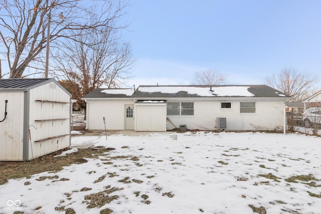 snow covered house with cooling unit