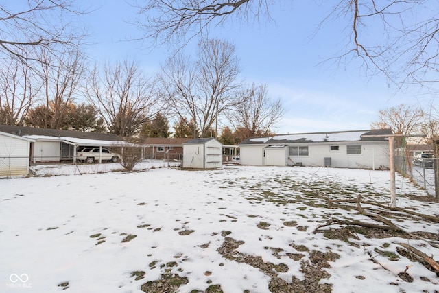 snow covered property featuring a shed