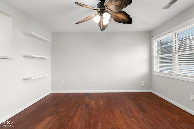 unfurnished room with dark hardwood / wood-style flooring and ceiling fan