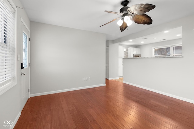 unfurnished living room with ceiling fan and light wood-type flooring