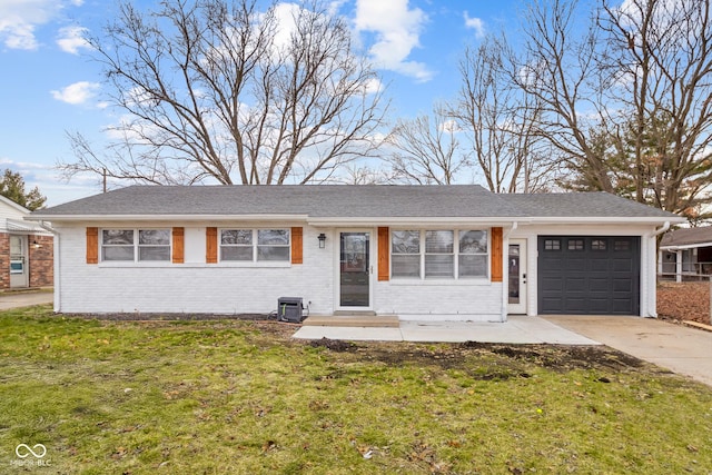 single story home featuring a garage and a front lawn