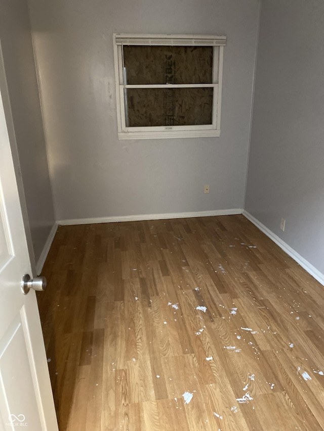 empty room with hardwood / wood-style floors