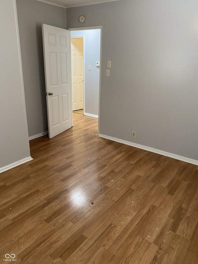 unfurnished room with hardwood / wood-style flooring