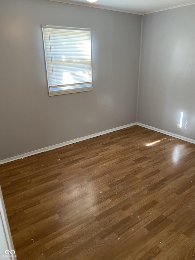 unfurnished room with dark hardwood / wood-style flooring