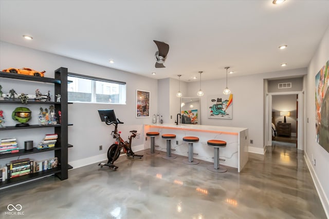 interior space with a breakfast bar and pendant lighting