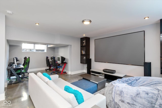 cinema room featuring concrete floors