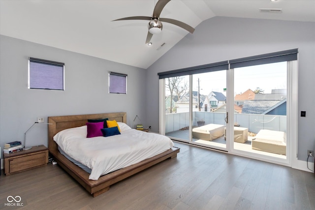 bedroom featuring ceiling fan, wood-type flooring, access to exterior, and vaulted ceiling