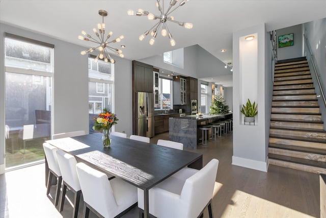 dining area featuring plenty of natural light, dark hardwood / wood-style floors, and a notable chandelier