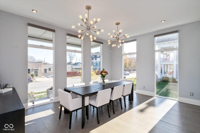 dining room featuring a notable chandelier and dark hardwood / wood-style flooring