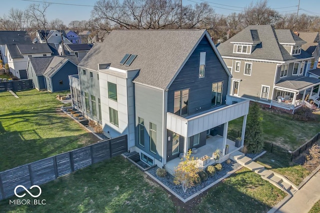 rear view of property with a lawn and a patio