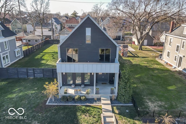 back of property with a yard and a patio area