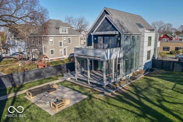 back of house with a yard, a fire pit, and a patio