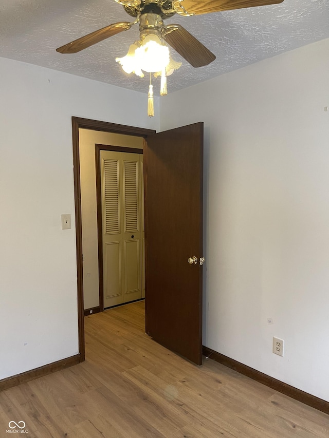 empty room featuring light hardwood / wood-style floors and a textured ceiling