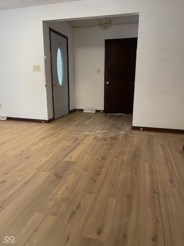 foyer entrance with light hardwood / wood-style flooring