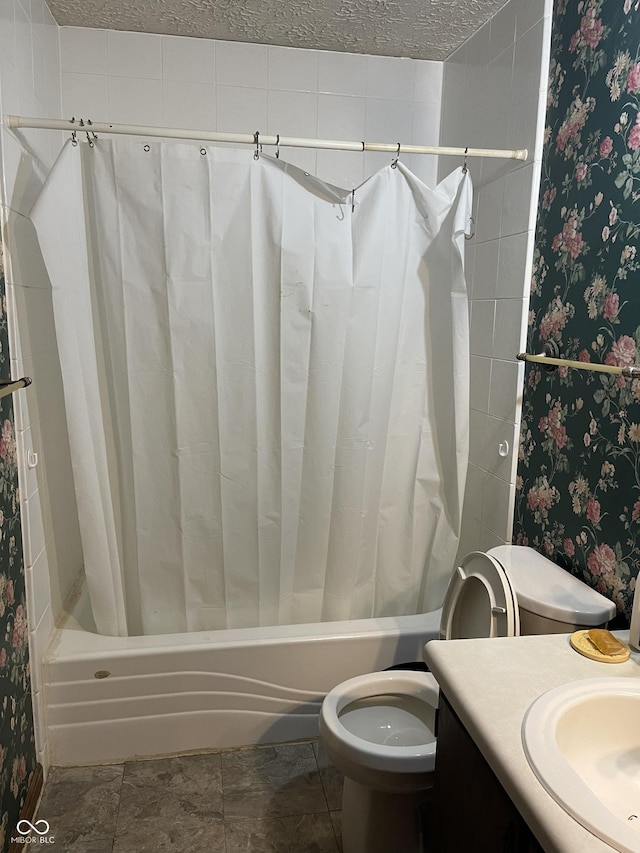 bathroom with vanity, a textured ceiling, and toilet