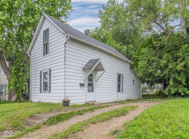 view of side of home with a lawn