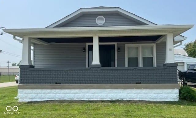 view of front facade featuring brick siding and covered porch