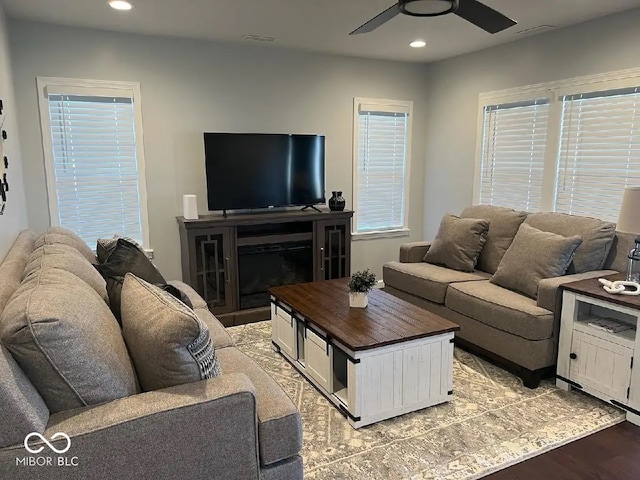 living area with recessed lighting, a ceiling fan, and light wood finished floors