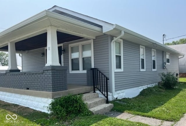 view of property exterior with covered porch