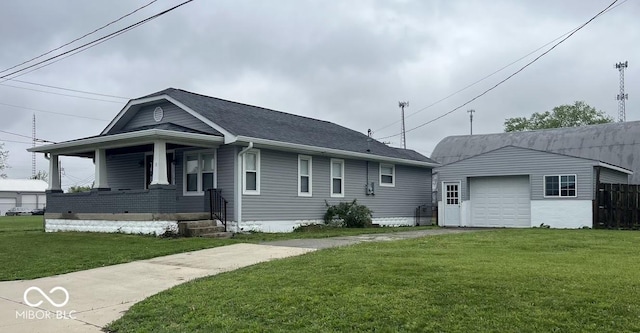 view of front of house with an outdoor structure, a front lawn, driveway, and covered porch