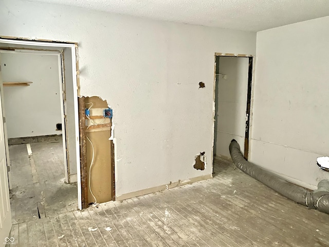 unfurnished room with a textured ceiling