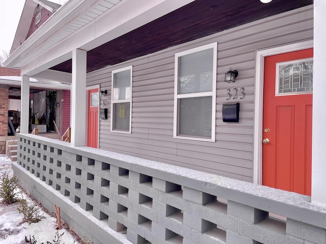 view of snow covered exterior with a porch