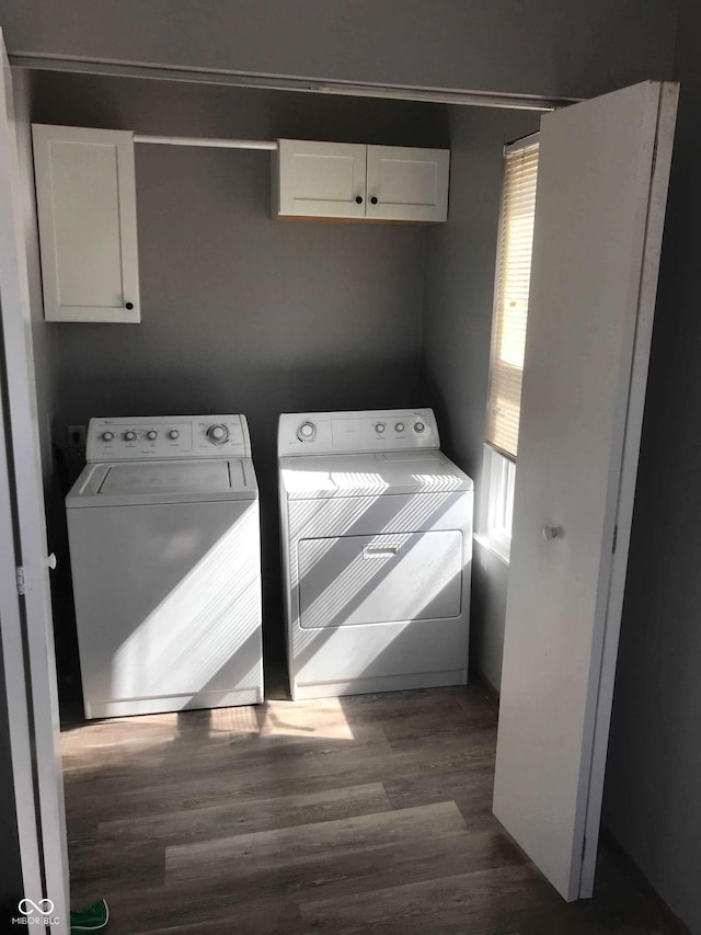 washroom with cabinets, dark wood-type flooring, and washer and clothes dryer