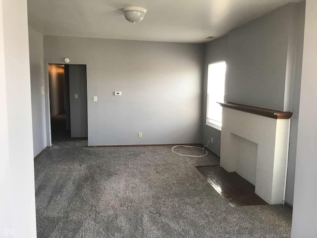 unfurnished living room featuring dark colored carpet