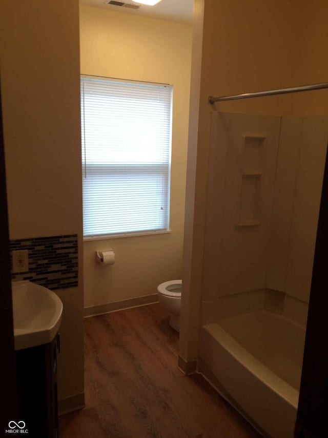 full bathroom with vanity, toilet, bathing tub / shower combination, and hardwood / wood-style floors