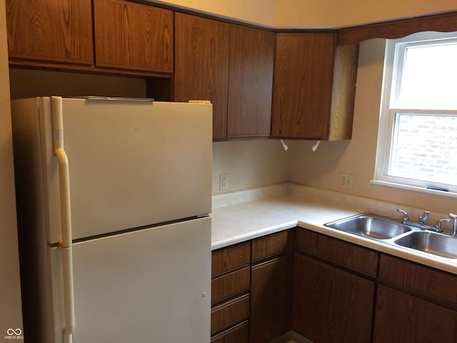 kitchen with sink, a healthy amount of sunlight, and white refrigerator