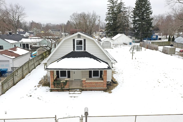 view of snow covered back of property