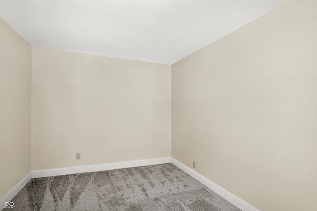 spare room featuring light colored carpet