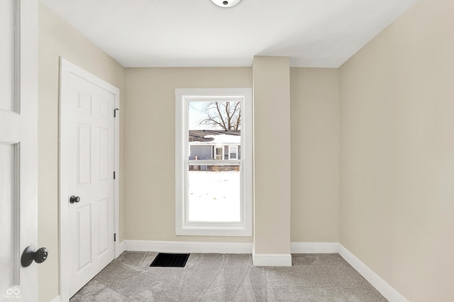 entryway featuring light colored carpet