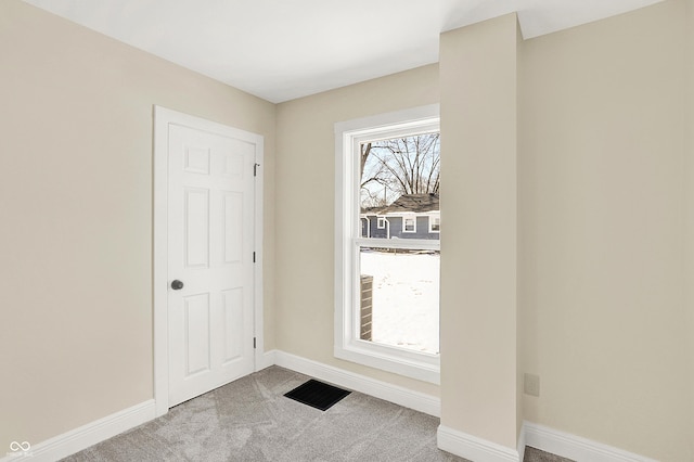 view of carpeted foyer entrance