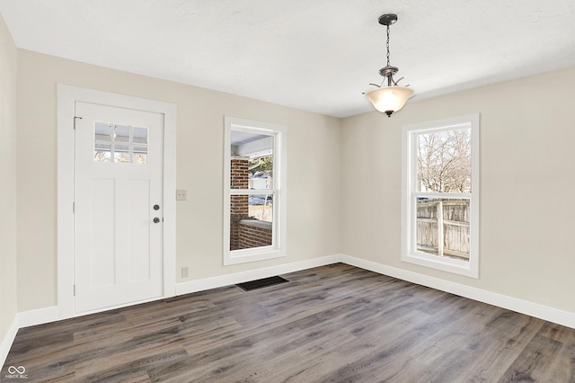 entryway with dark hardwood / wood-style flooring