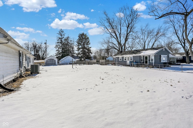 yard covered in snow with cooling unit