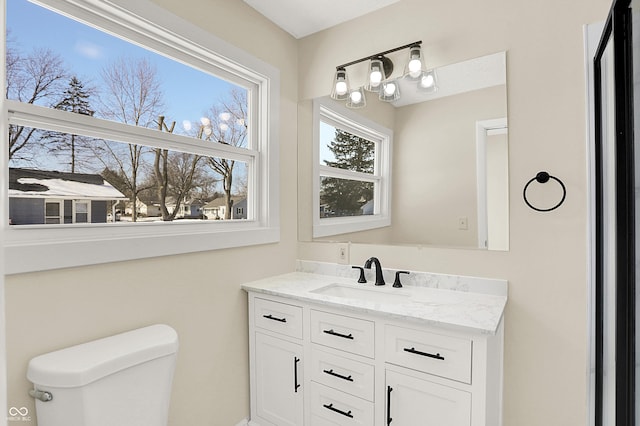 bathroom featuring vanity and toilet