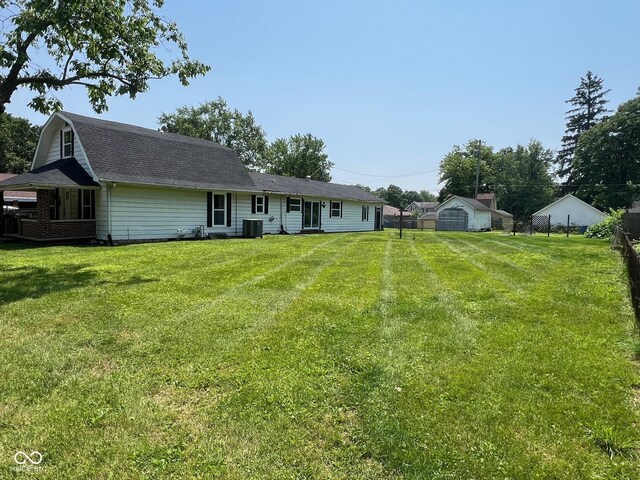 1175 Central Ave, Noblesville, IN 46060 - rear view of house with roof with shingles, a gambrel roof, and a yard
