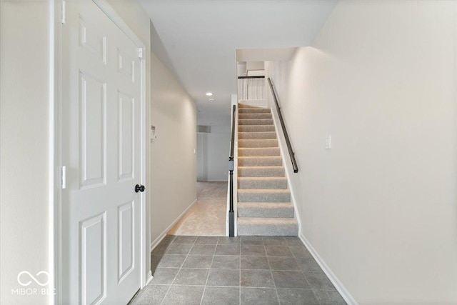 staircase featuring tile patterned flooring