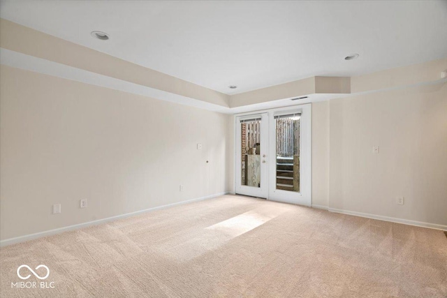 unfurnished room featuring light colored carpet and french doors