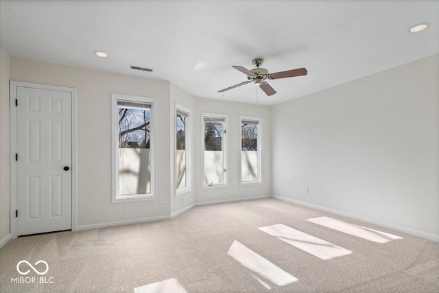 carpeted empty room featuring ceiling fan