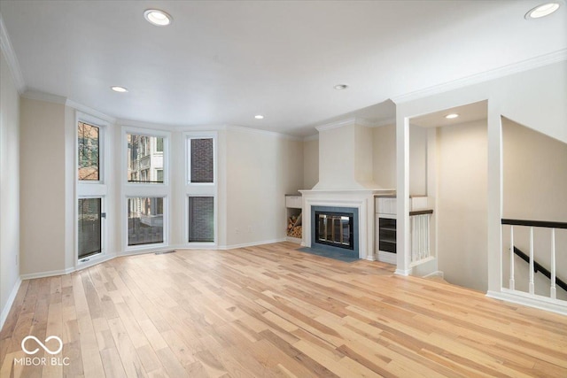 unfurnished living room with crown molding and light wood-type flooring